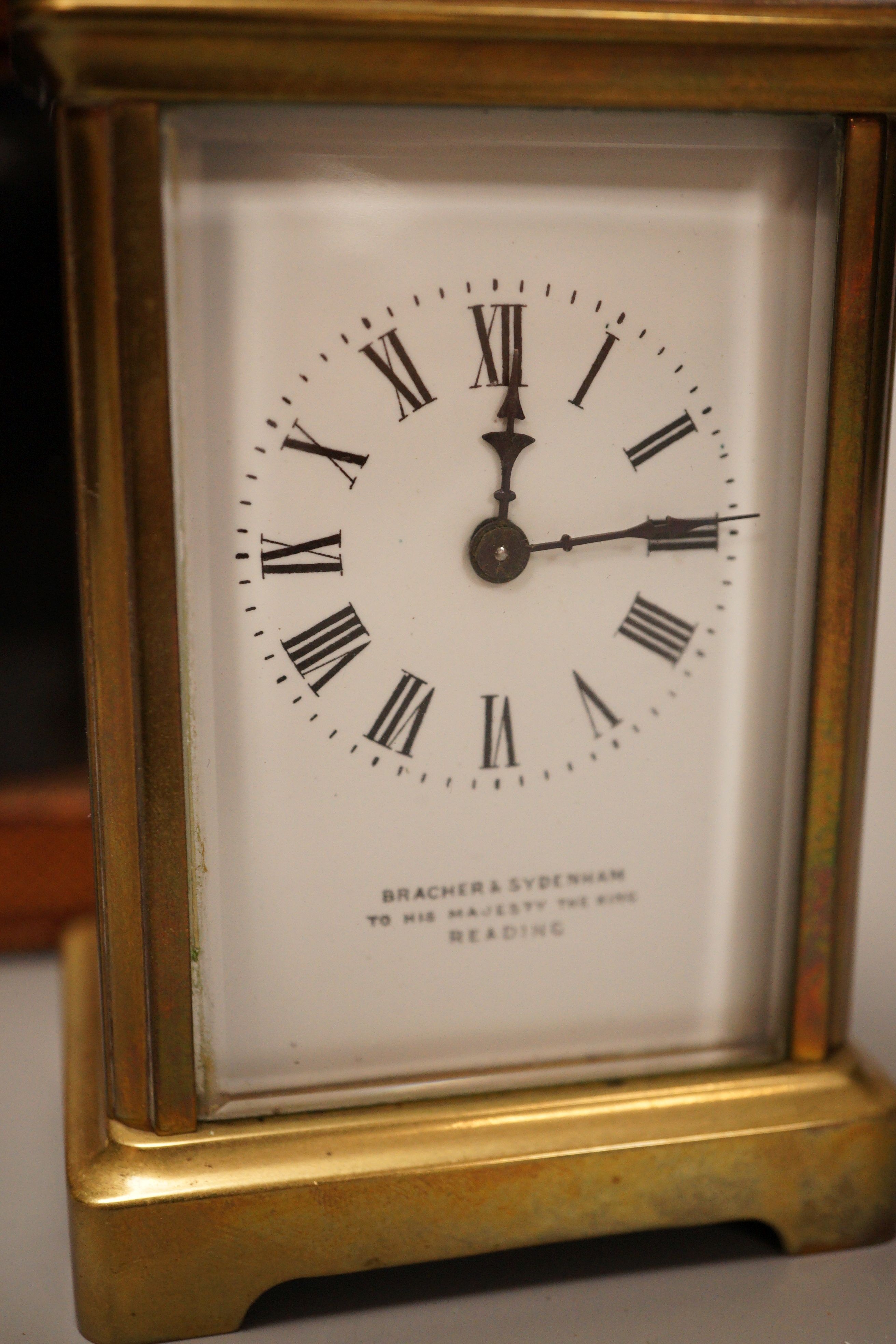 A leather cased brass carriage timepiece, retailed by Bracher & Sydenham